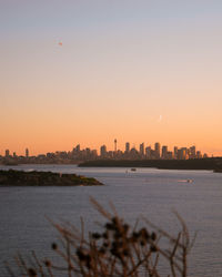 Scenic view of city against sky during sunset