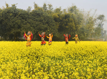 Rear view of woman walking on field