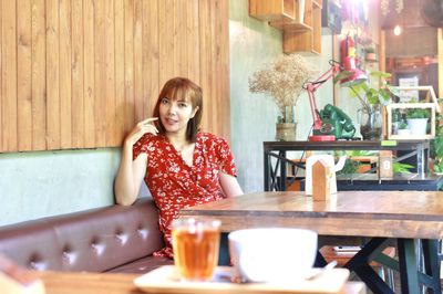 Portrait of smiling woman sitting at restaurant