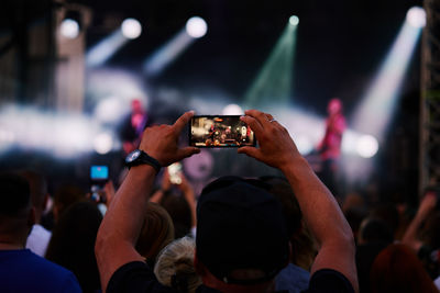 People crowd near stage enjoys musician band's performance