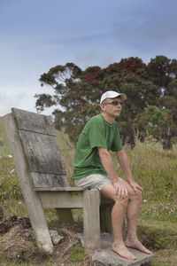 Full length of man sitting against sky