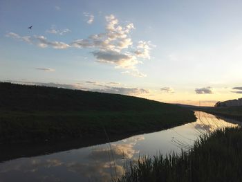 Scenic view of lake against sky during sunset