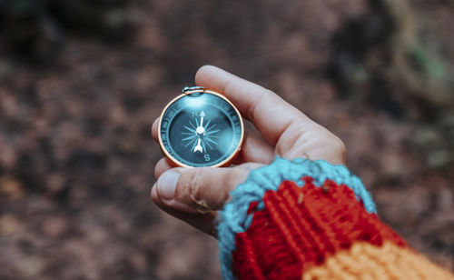 Cropped hand holding navigational compass