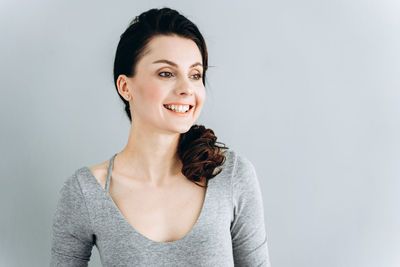 Portrait of a smiling young woman over white background