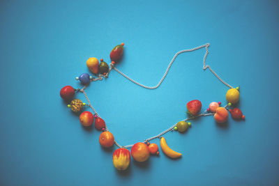 High angle view of berries on table against blue background