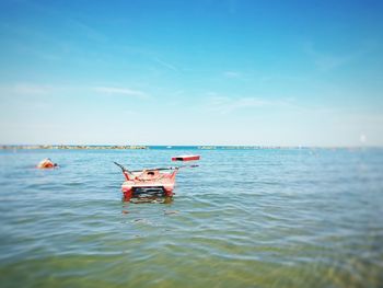 Man in sea against sky