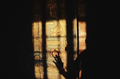 Shadow of man on building wall in temple