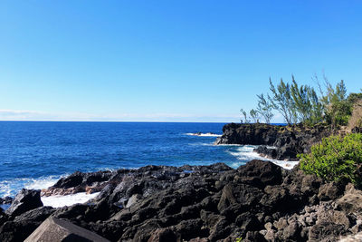 Scenic view of sea against clear blue sky