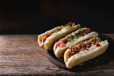 Close-up of hot dog on table against black background