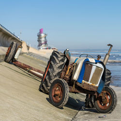 View of motorcycle on beach against clear sky