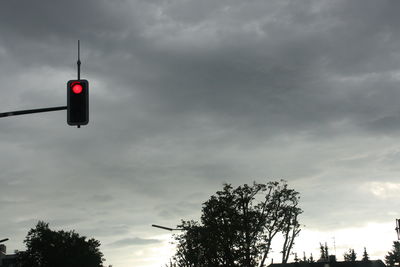 Low angle view of street light against cloudy sky