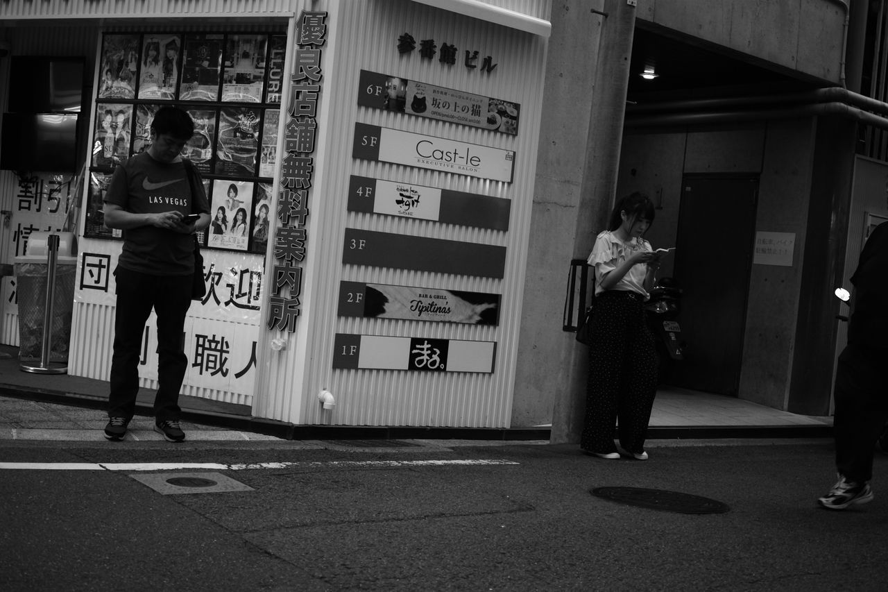 PEOPLE STANDING ON FOOTPATH BY CITY