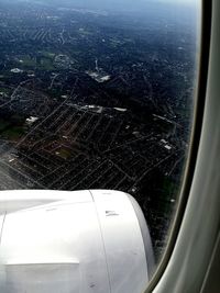 Aerial view of airplane wing seen through window