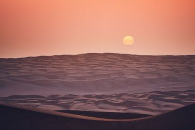 Scenic view of desert against sky during sunset