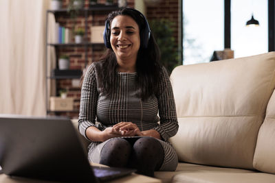 Young woman using laptop at home