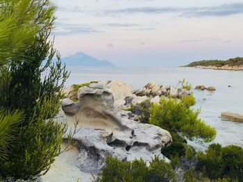 Scenic view of rocks on beach against sky