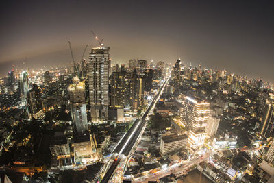 High angle view of illuminated city buildings against sky