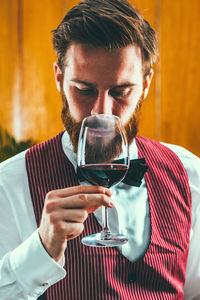 Close-up sommelier looking at wine in glass