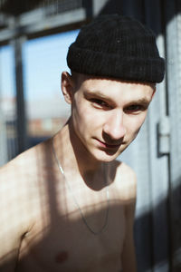 Portrait of shirtless young man wearing hat