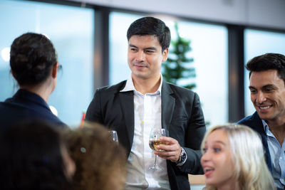 Portrait of a smiling young man drinking glass