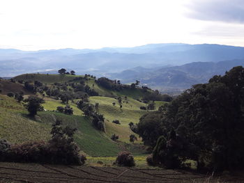 Scenic view of landscape and mountains against sky