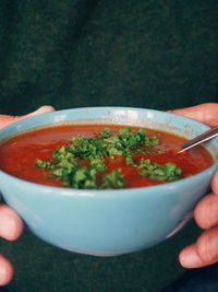 Midsection of man of holding soup bowl