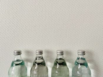 View of empty bottles against white background