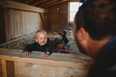 Portrait of father and son on wood