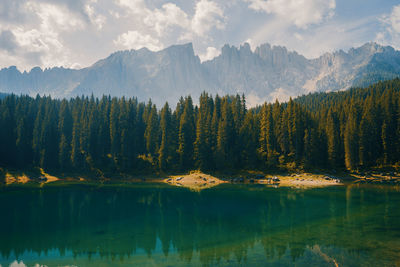 Scenic view of lake by mountains against sky