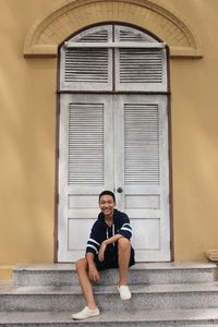 Portrait of smiling man sitting on steps