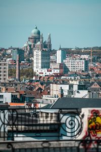 Buildings in city against clear sky