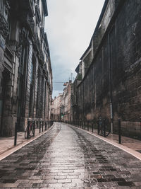 Street amidst buildings against sky in city