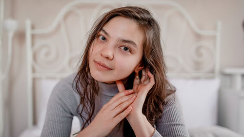 Portrait of young woman sitting at home