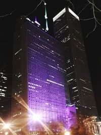 Low angle view of illuminated cityscape at night