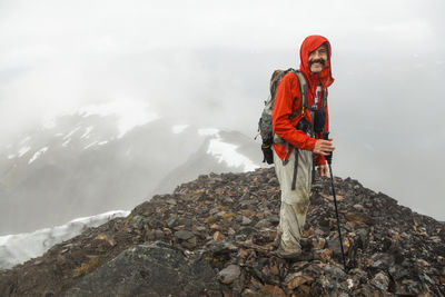 Man stands on summit of cooper mountain, kenai peninsula, alaska