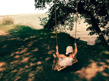 Child sitting on swing