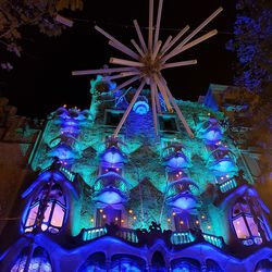 Low angle view of illuminated christmas lights at night