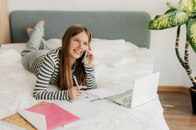 Young woman using laptop at home