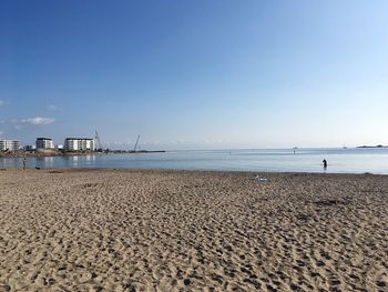 Scenic view of beach against clear blue sky