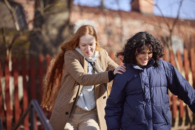 Smiling female friends in park