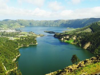 Scenic view of calm lake against cloudy sky