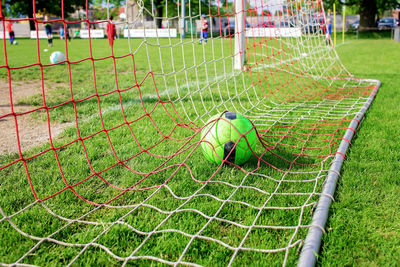 Soccer gears on green grass prepared for training in kids football academy. popular sport activity