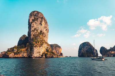 Rock formations in sea against sky