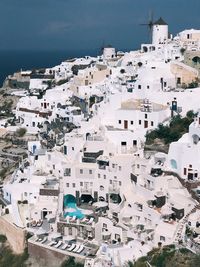 High angle view of townscape by sea against sky