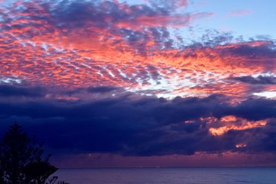 Low angle view of dramatic sky over sea