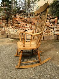 Empty chairs and table against wall