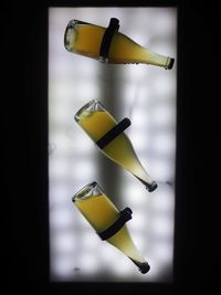 Close-up of yellow glass bottle on table