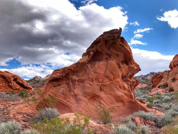 Low angle view of rock formation against cloudy sky