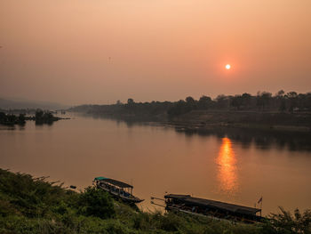 Scenic view of lake against sky during sunset