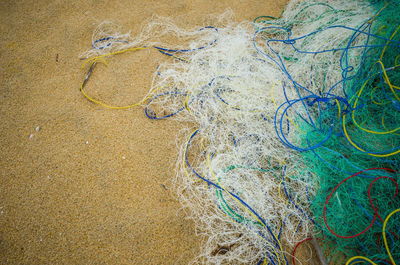 High angle view of fishing net on beach